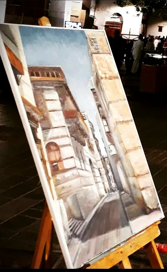 Painting of a historic building facade displayed on an easel
